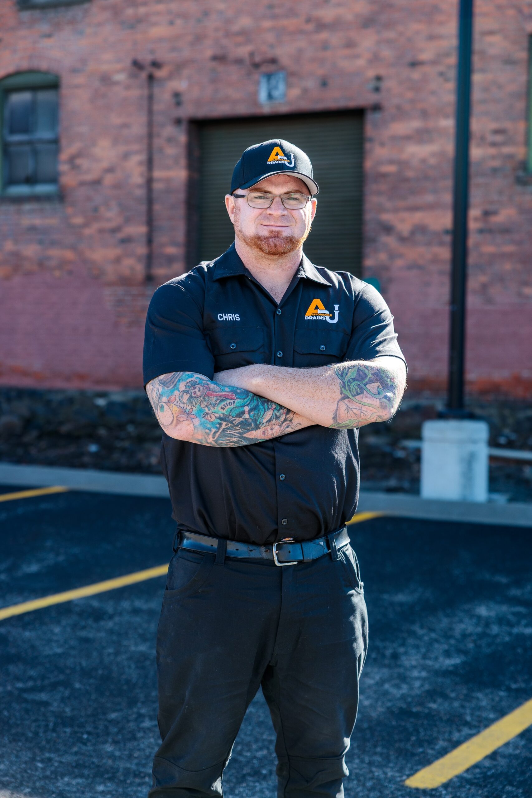 Chris, a professional technician at Affordable Drains, standing confidently in uniform in Spokane, Washington